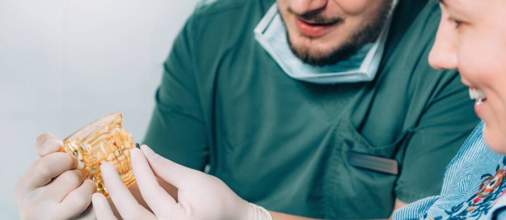 Dentist explaining dental model to smiling patient 2026 01 05 23 00 24 utc bij Trail Verwijskliniek